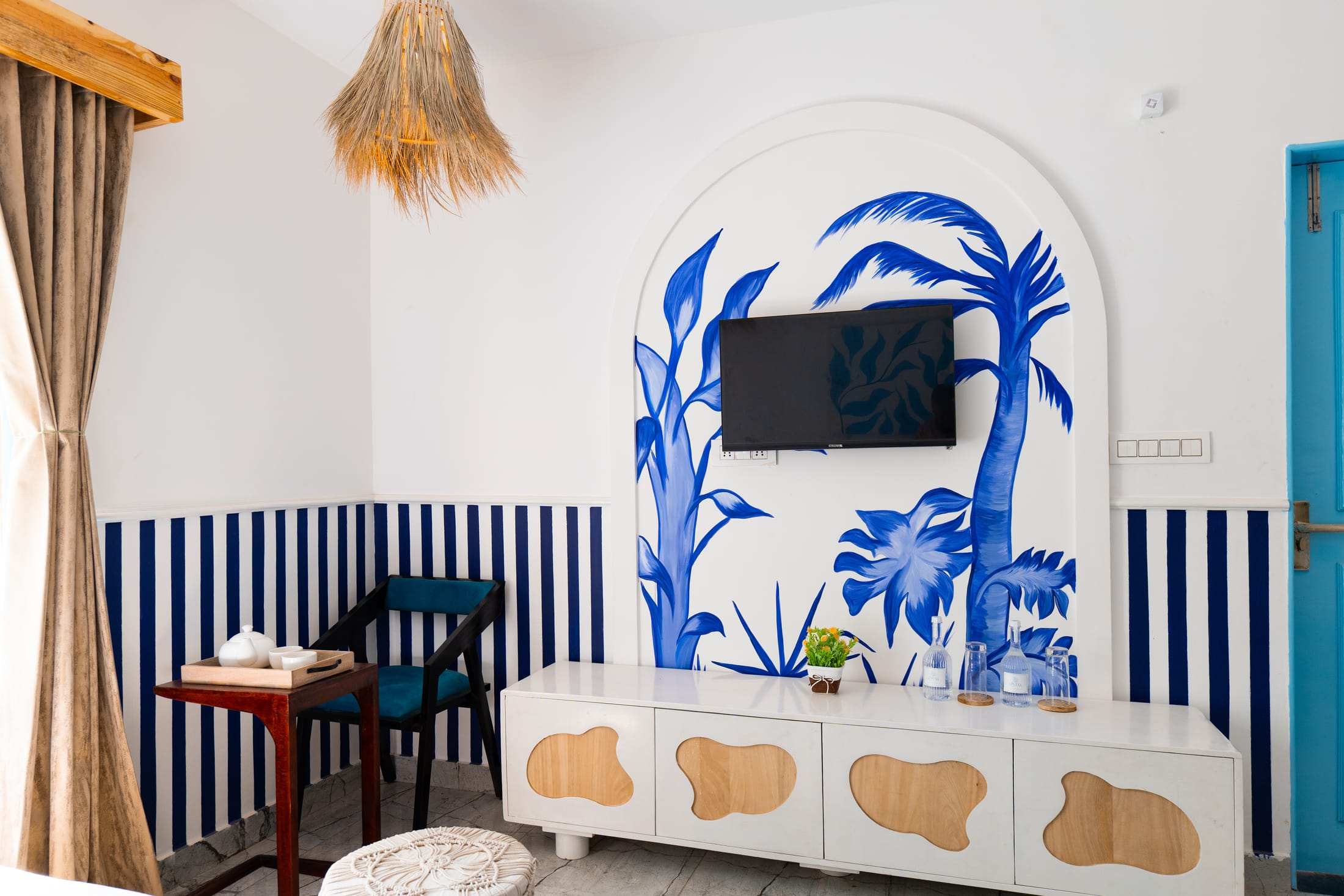 Palm mural, TV and cream console in Athena's Alcove