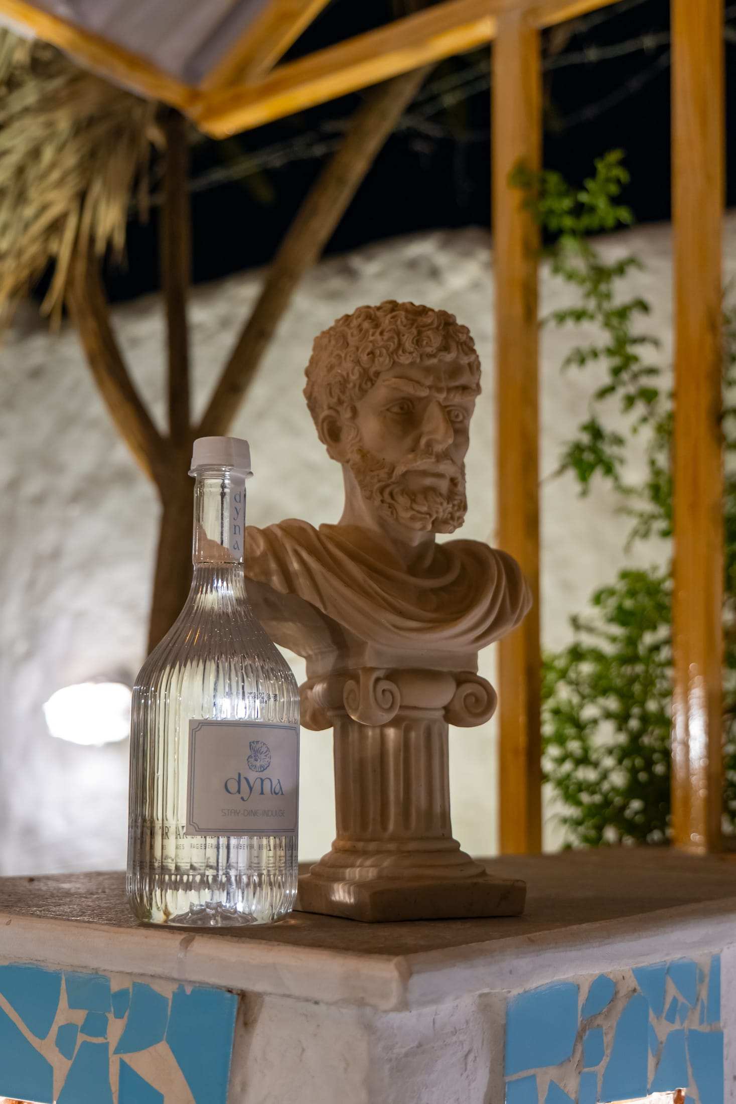 Greek stone bust and a bottle as a decor detail at reception