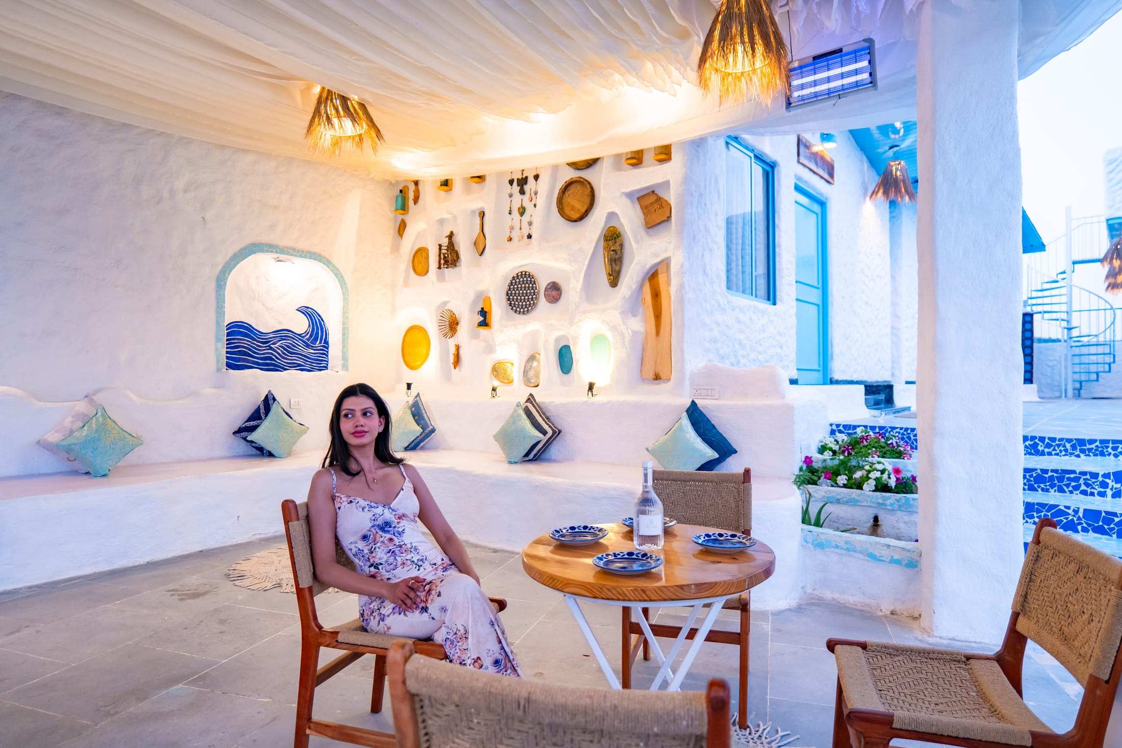Guest seated in the lounge niche with glowing wall decor in the evening