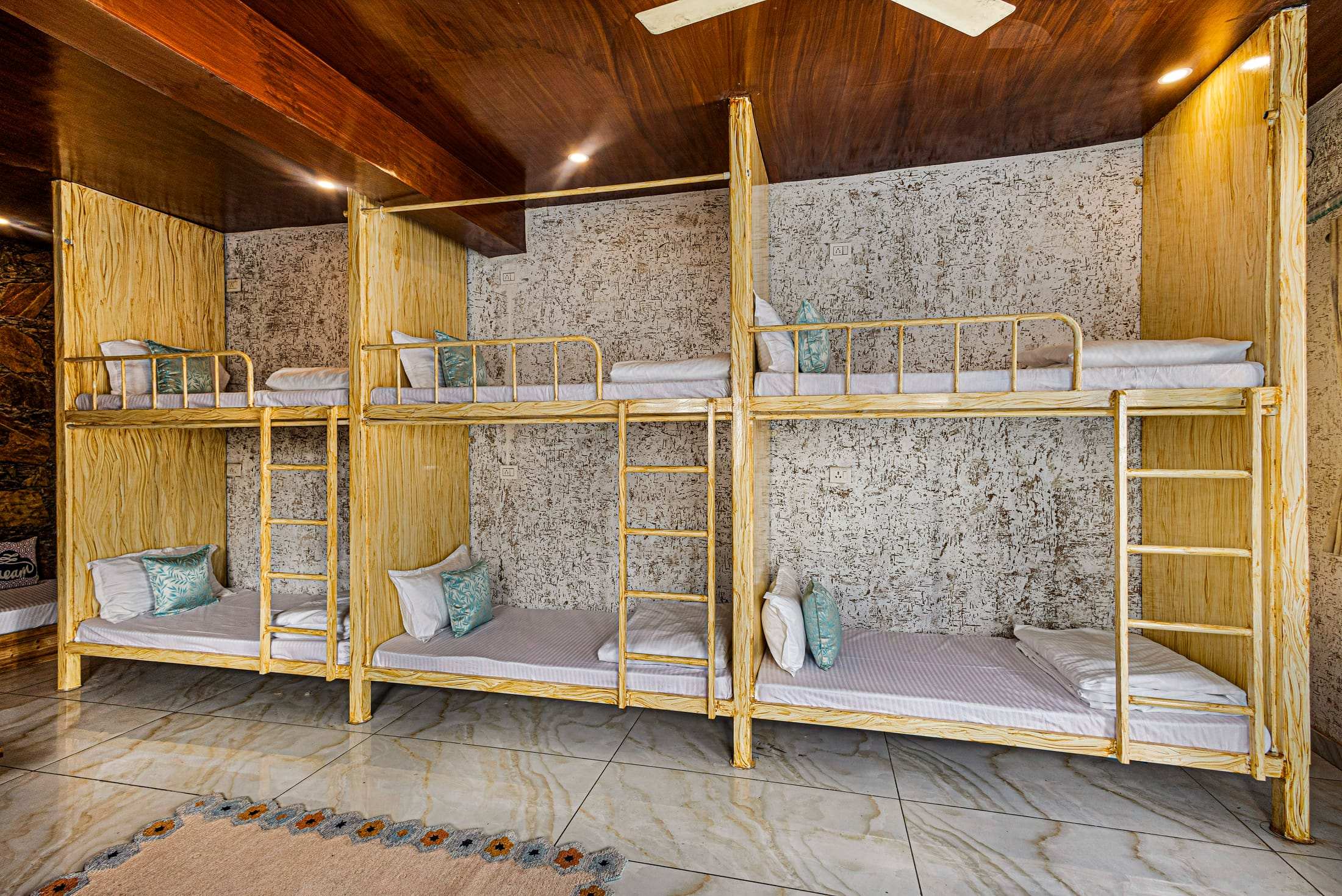 Wooden bunk beds with ladders in Noe's Nest dormitory