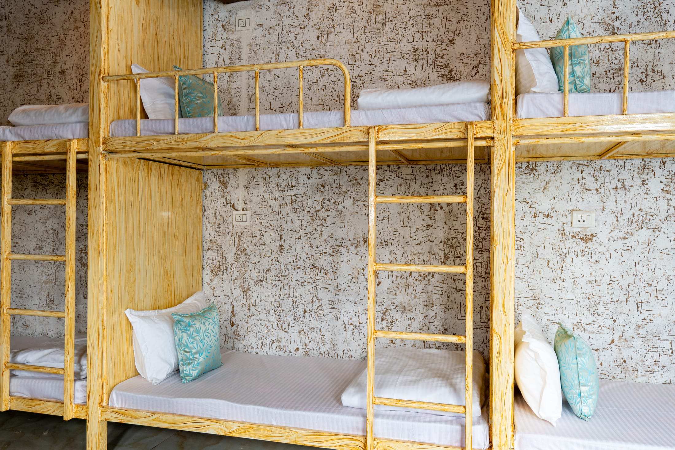Close view of a bunk bed with cushions and ladder