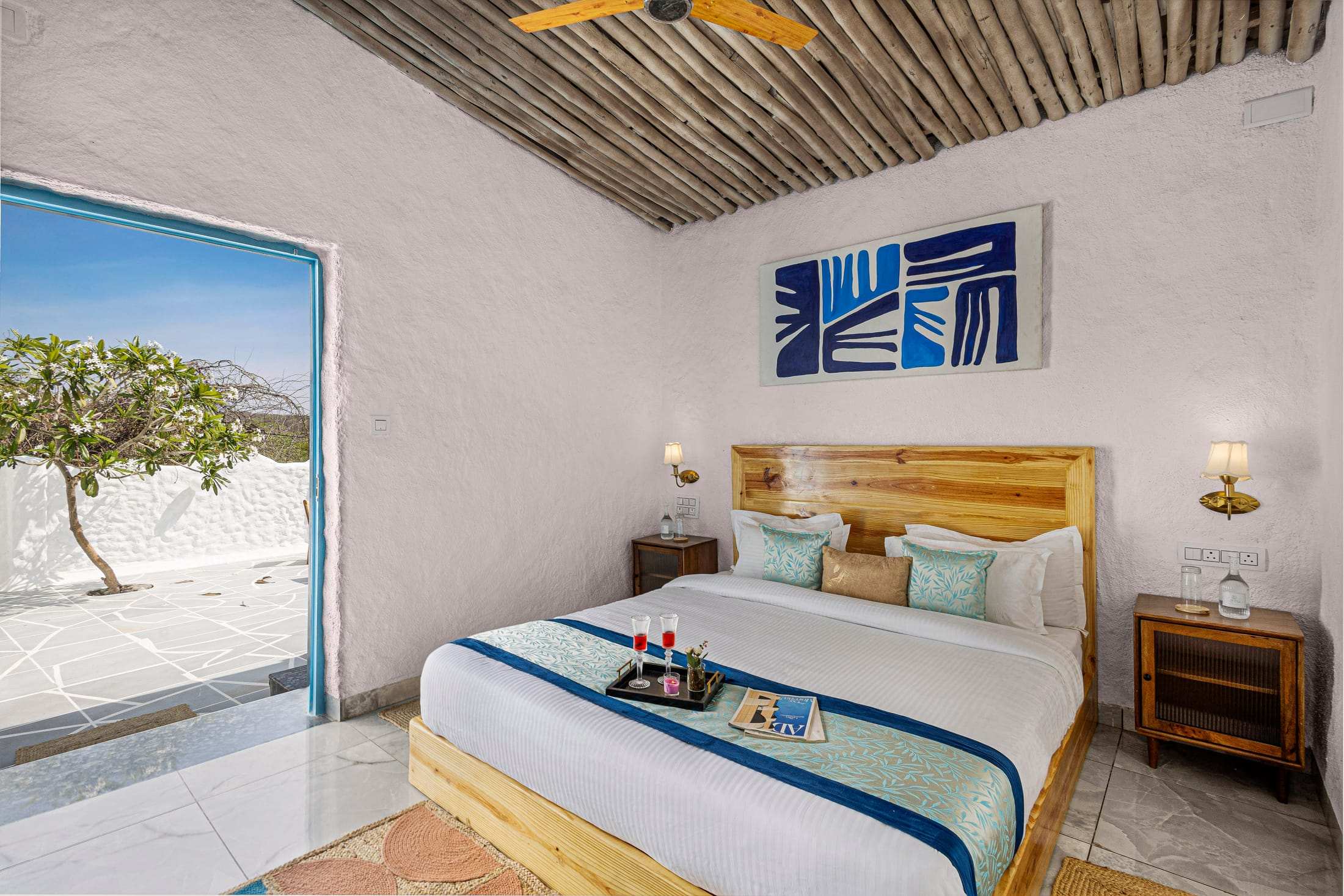 Santorini Suite bed beside an open door to the garden