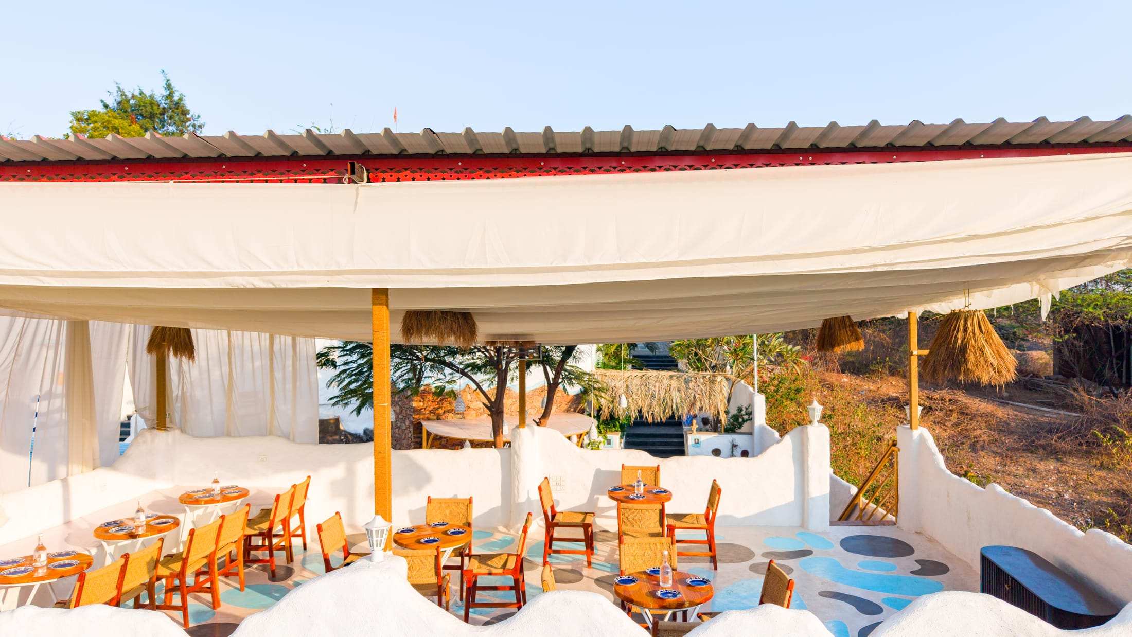 Aerial view of the 510 sq ft terrace café with draped white canopy and tables